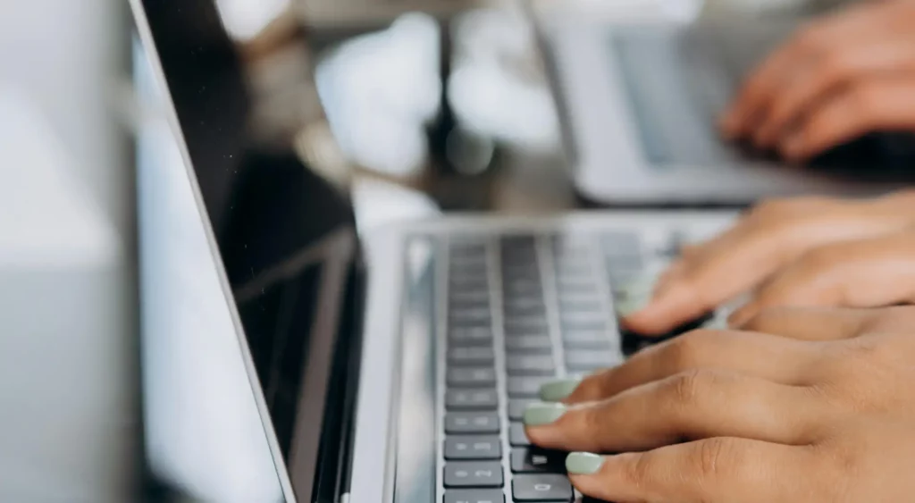 Photo by Mikhail Nilov: https://www.pexels.com/photo/selective-focus-photo-of-a-person-with-green-manicured-nails-typing-on-a-laptop-6894207/